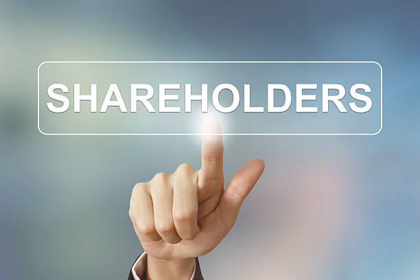 business hand clicking shareholders button on blurred background business hand pushing shareholders button on blurred background shareholder stock pictures, royalty-free photos & images