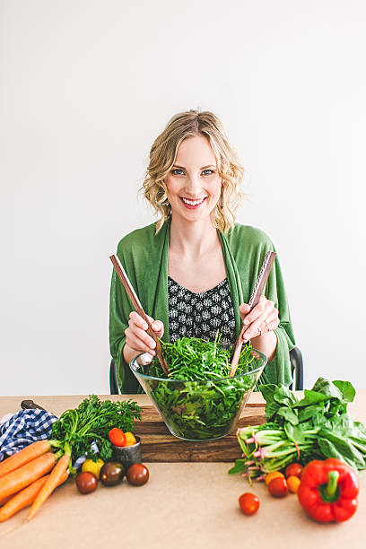 istock Young woman making fresh salad 478582444