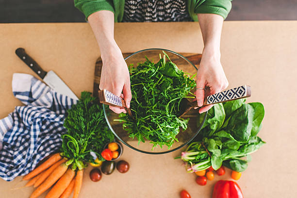 istock Young woman making fresh salad 478582458