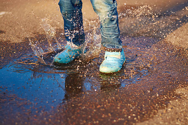 istock The child jumps in a puddle 478582586