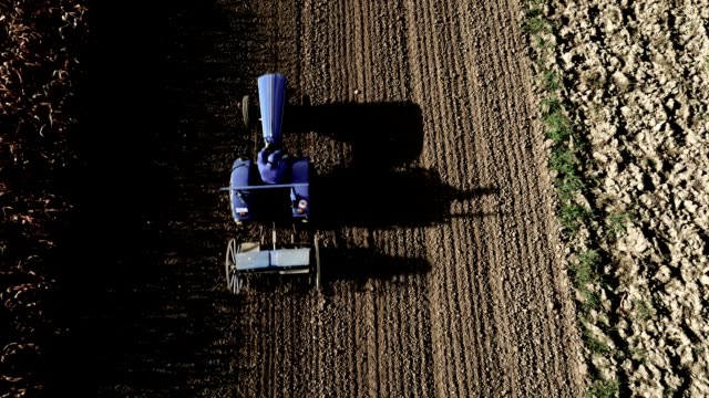 AERIAL Farmer Harrowing A Field