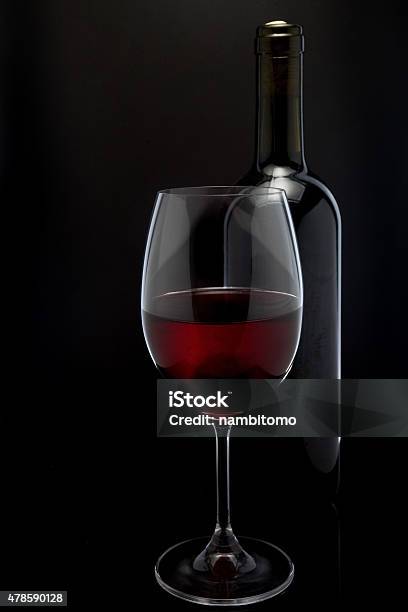 Red Wine Glass And A Bottle In Black Background Stock Photo - Download Image Now - Black Background, Bottle, In Silhouette