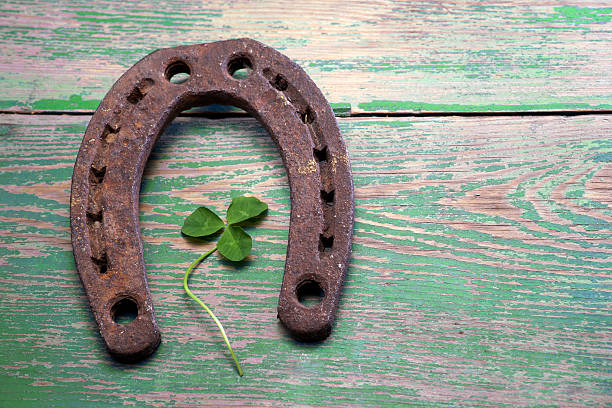 istock Old iron rusty metal horseshoe on weathered wood 478593380