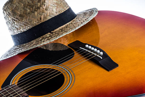 istock Acoustic Guitar Bridge and a Panama hat 478594060