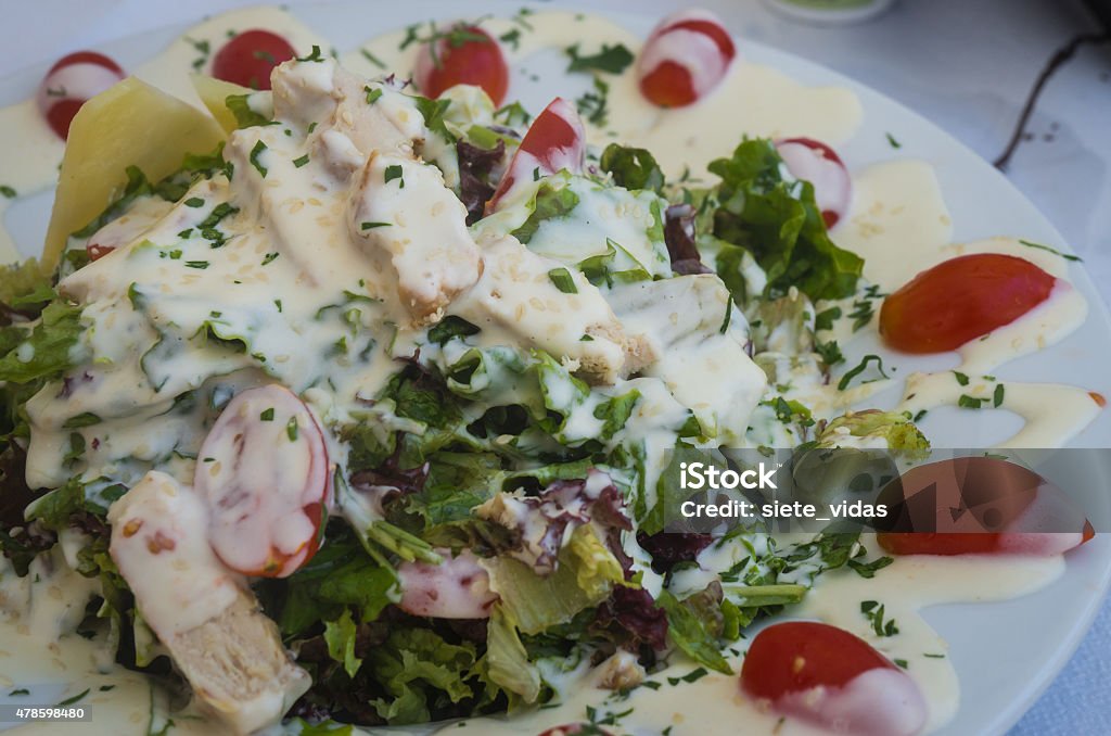 Argontula salad with cherry tomatoes, arugula, chicken and speci Image of argontula salad with cherry tomatoes, arugula, chicken and special sauce, Milos island? Greece 2015 Stock Photo