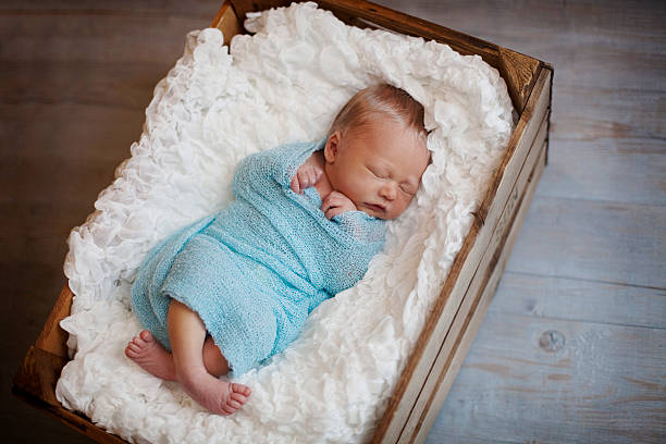 istock Newborn Baby Boy Sleeping in Apple Crate 478598546