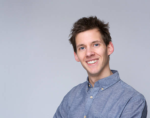 istock Smiling young man posing against gray background 478602681