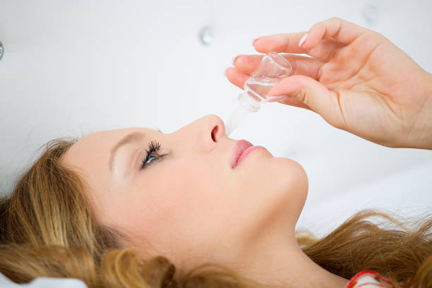 istock Closeup of Sick woman using nasal drops. 478602771