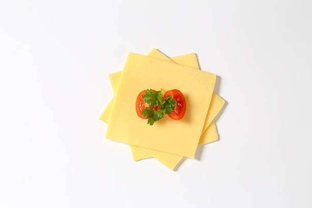 cheese slices fresh cheese slices with tomato and parsley on white background edam stock pictures, royalty-free photos & images