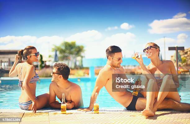 People Enjoying Drinks By The Swimming Pool Stock Photo - Download Image Now - Tourist Resort, Community, Drinking