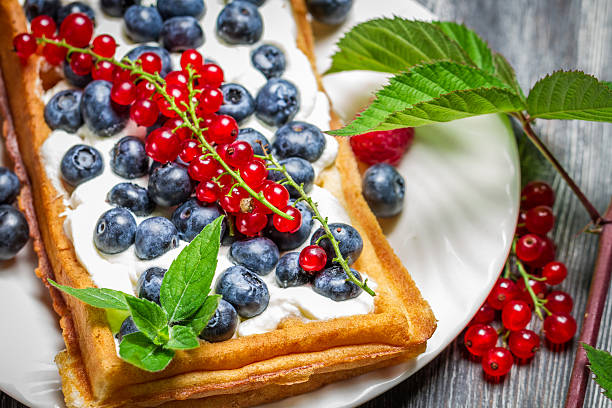 Waffels with cream and berry fruits.