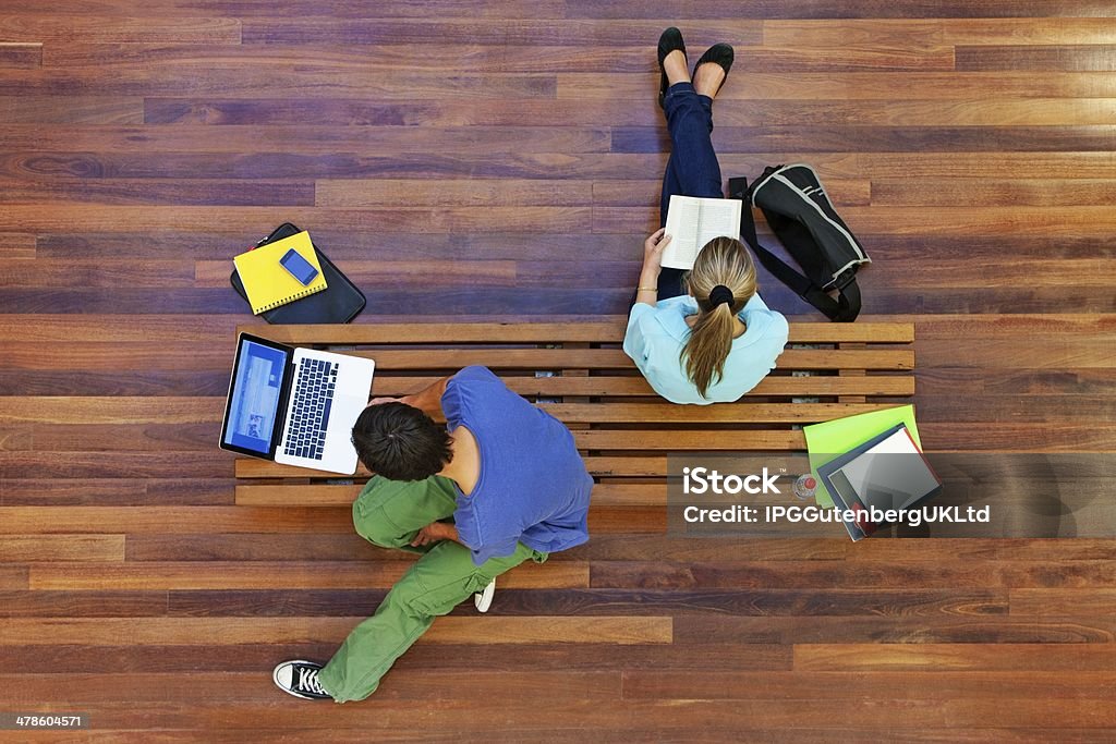 Top view of male and female university students studying Top View Of University Students Studying Adult Stock Photo