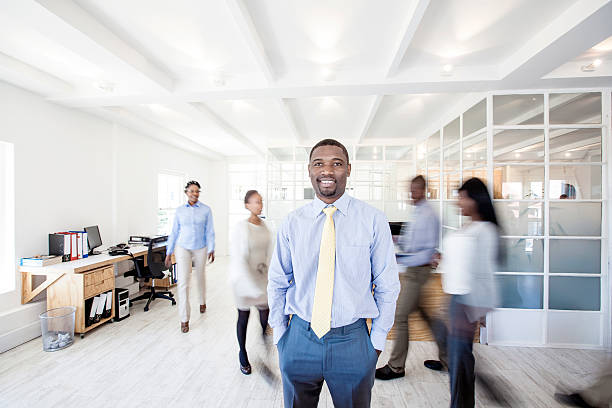 istock African businessman looking at the camera with team in background 478604907