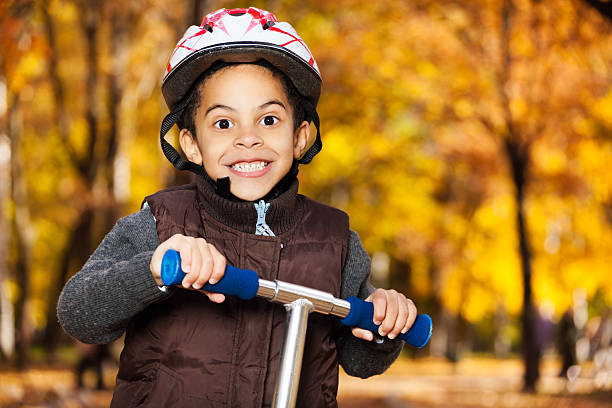 istock Close portrait of boy riding a scooter 478608697