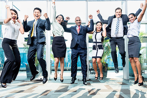 разнообразие business team celebrating success прыжки - success businessman corporate business ecstatic стоковые фото и изображения