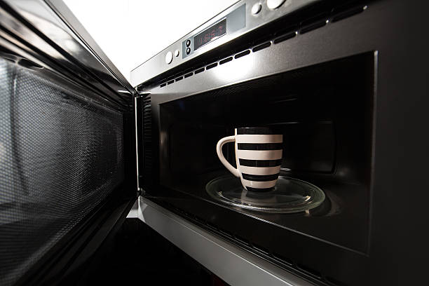 heating a hot mug in the microwave stock photo