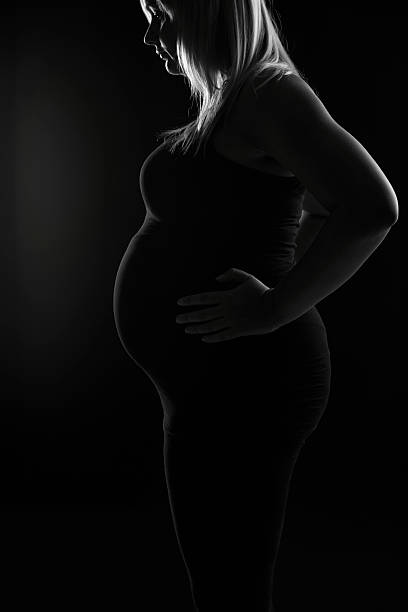 istock Artistic lit blond pregnant woman 478617632