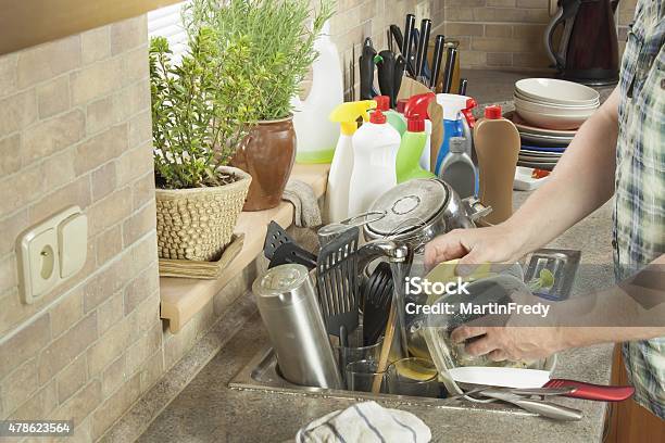 Man Washing Dirty Dishes In The Kitchen Sink Stock Photo - Download Image Now - 2015, Adult, Adults Only