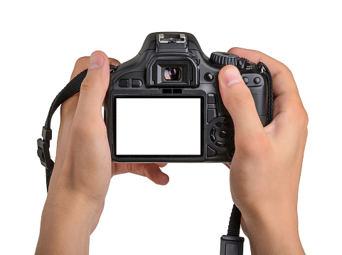 DSLR camera in hand isolated