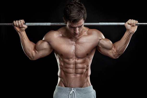 bodybuilder физические упражнения с гантелями - men body building human muscle muscular build стоковые фото и изображения