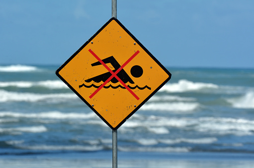 New Zealand sea warning sign at the beach with man swim and not symbol, Caution No Swimming allowed. concept conceptual.