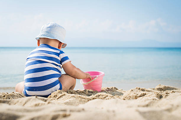 istock Cute baby boy playing with beach toys 478630686