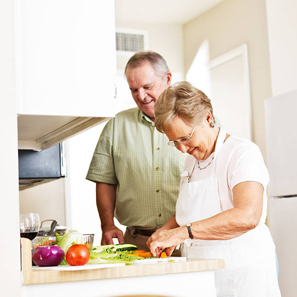 istock elderly married couple cooking dinner 478630937