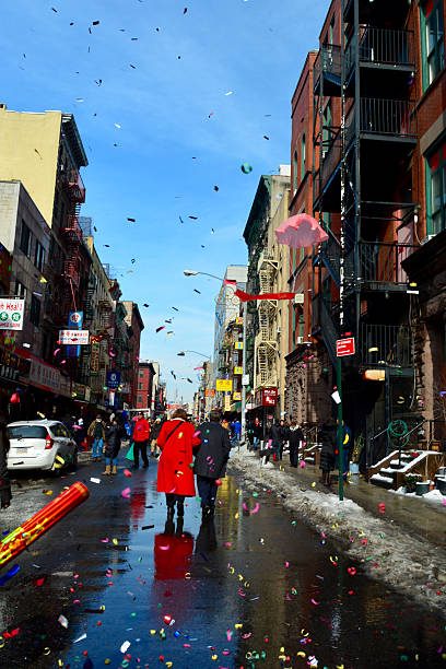 New York, USA - February 22, 2015: People walking away after Chinese New Year parade in the streets of New York Chinatown.