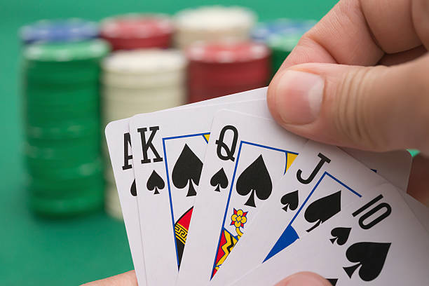 istock poker player holding 10 to King, A spade  is coming 478632278