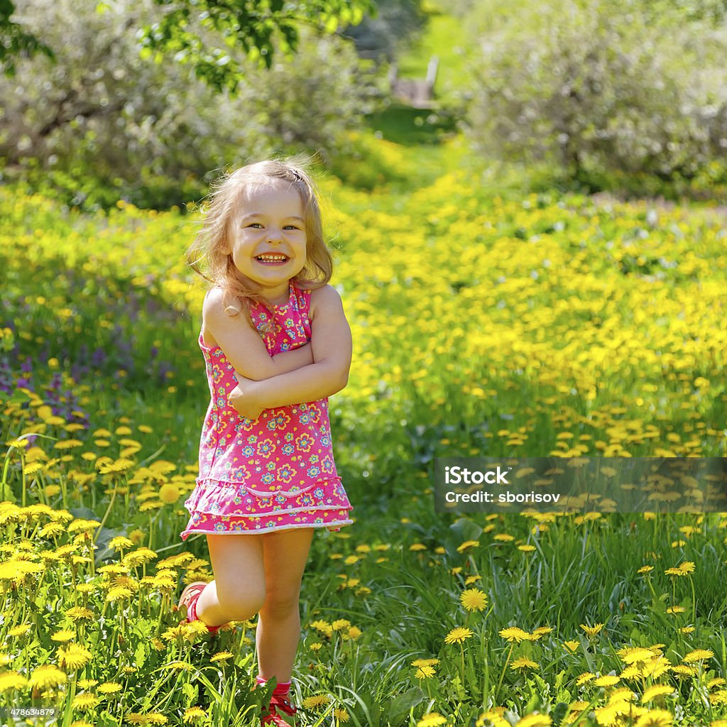 Little girl in the park Little girl playing in the spring park Agricultural Field Stock Photo