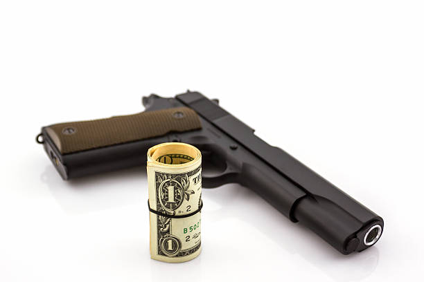 istock Close up money with Gun . 478635094