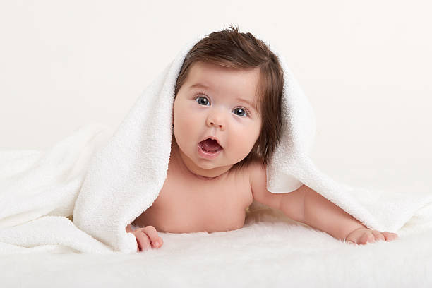 istock happy baby under towel on white 478636246