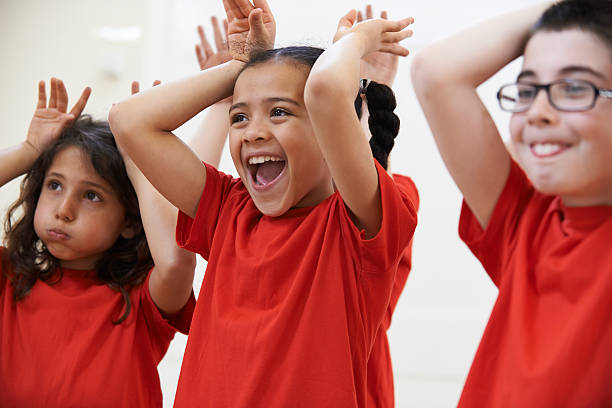 Group Of Children Enjoying Drama Class Together Group Of Children Enjoying Drama Class Together high school student child little boys junior high stock pictures, royalty-free photos & images