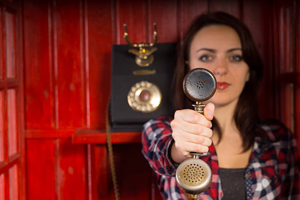 istock Woman holding out a telephone handset 478639072