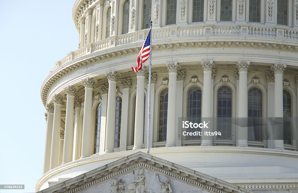 Capitol in Washington Flag of the United States on the Capitol Building in Washington, DC, USA. American Culture Stock Photo