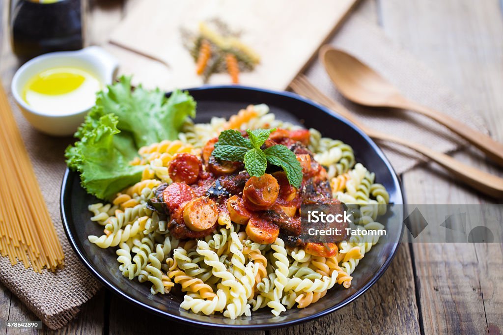 Italian spaghetti low angle view of a serving of Italian spaghetti on wood table 2015 Stock Photo