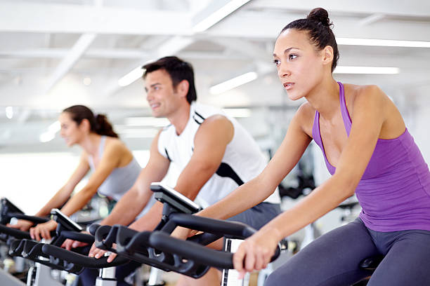 Shot of gym members participating in a exercising class