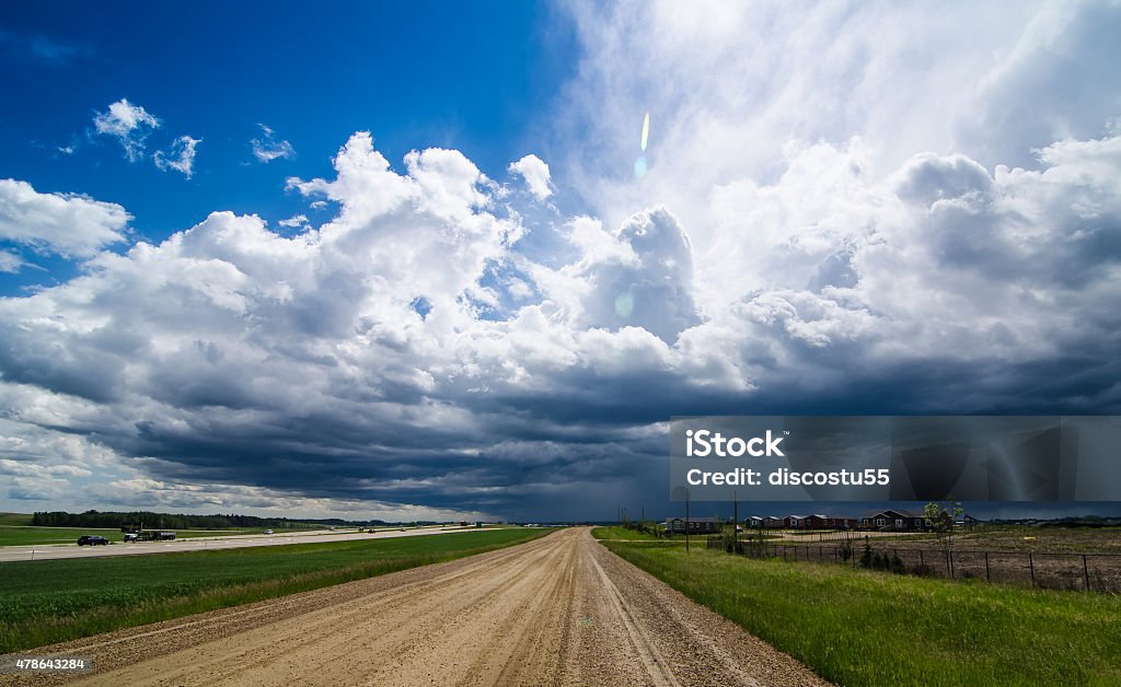 Storm Incoming A wide angle shot of a storm coming on over a prairie town.  2015 Stock Photo