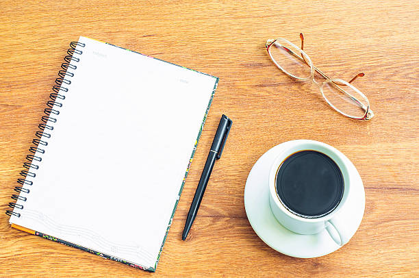 istock notebook black pen coffee cup on wooden background 478643760