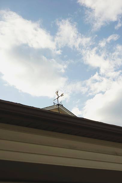 Weather Vane with Bright Clouds stock photo