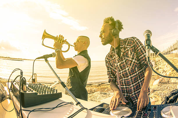 istock Trendy djs playing summer hits at sunset beach party 478649372