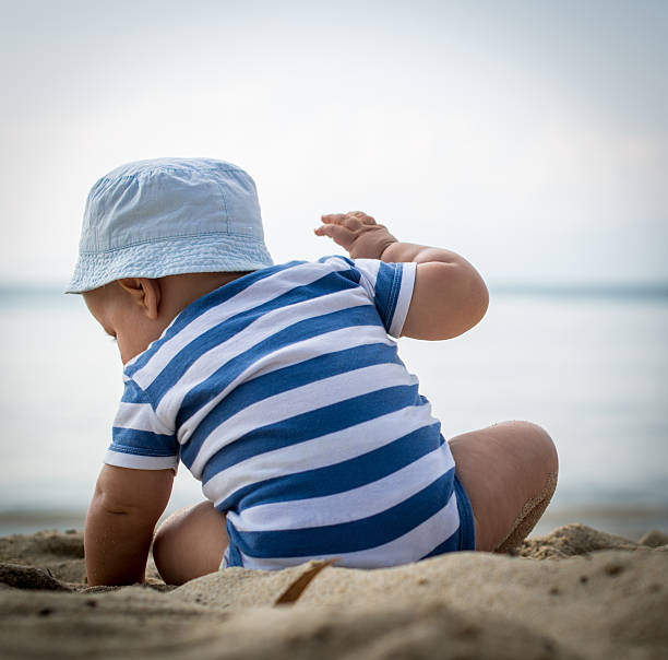 istock Cute baby boy playing on the beach 478649636