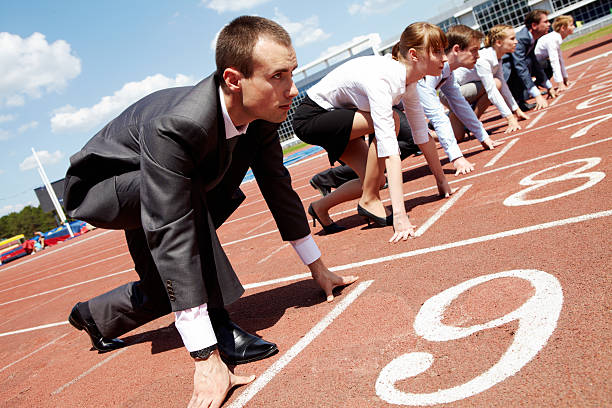 Career Row of business people getting ready for race rat race stock pictures, royalty-free photos & images