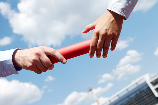 Passing baton Photo of business people hands passing baton during marathon rat race stock pictures, royalty-free photos & images