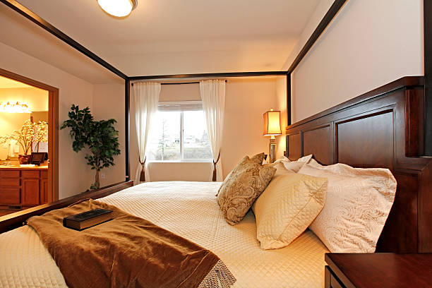 istock Warm beautiful bedroom with a high posts bed 478652479