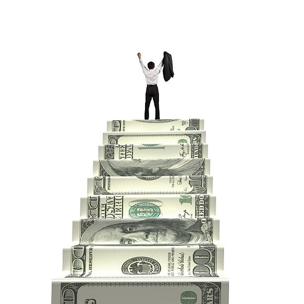 Man cheering on top of money stairs stock photo