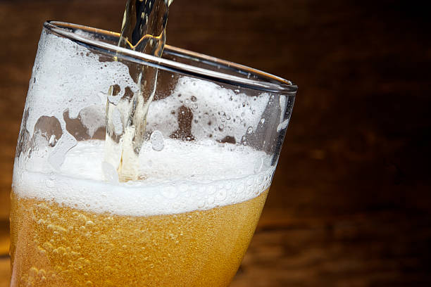 istock Beer into glass on a old wood 478656072