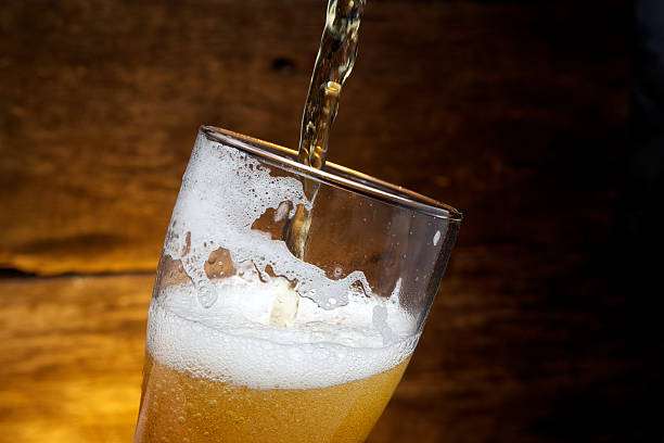 istock Beer into glass on a old wood 478656078