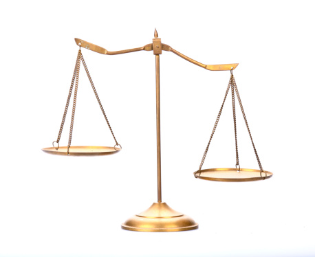 Still life of a scale of justice on white background