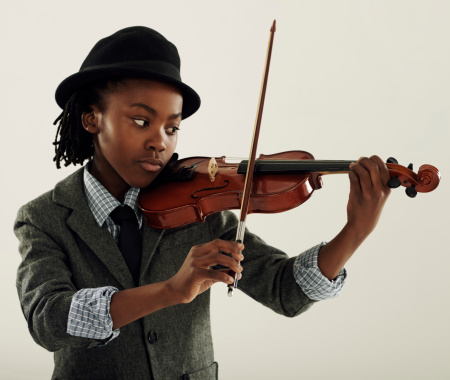 A young African-American boy playing a violin